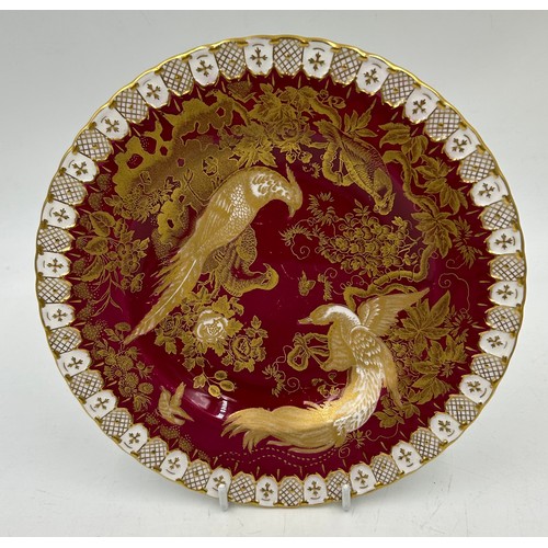 412 - Two royal Crown Derby plates, a Pink Chinese Birds in white relief and a red/gilt bird plate 21.5cm ... 