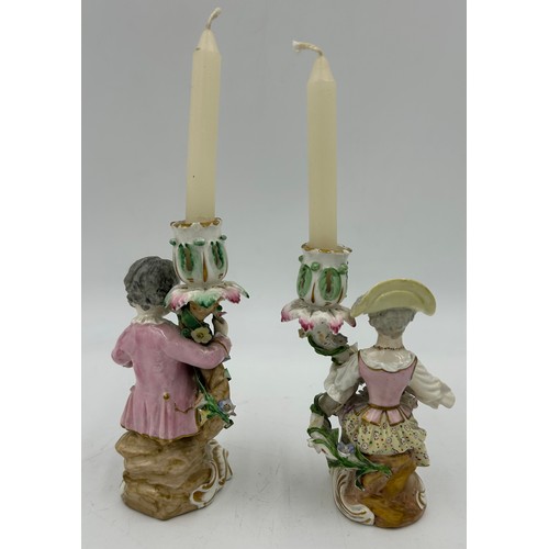 414 - A pair of late 19thC Meissen style Figural Candle Holders with decorative flowers 15cm h. Blue cross... 