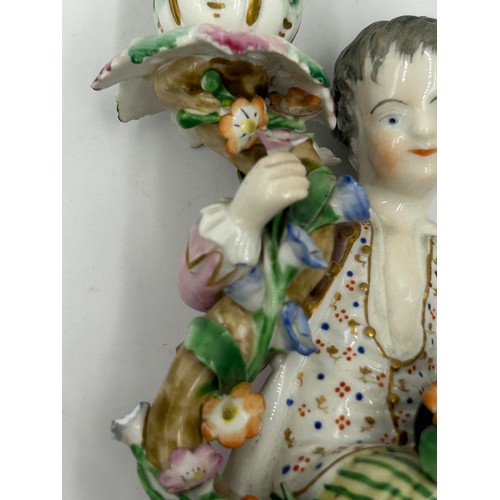 414 - A pair of late 19thC Meissen style Figural Candle Holders with decorative flowers 15cm h. Blue cross... 