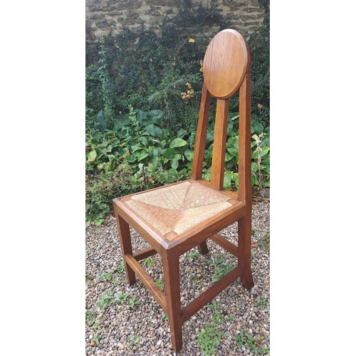 23 - A pair of Arts & Crafts rush seated oak chairs. 98cm h x 41cm w x 38cm d. Height to seat 42cm.