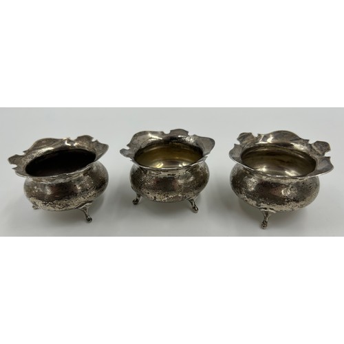 875 - Three Silver Salt Cellars engraved with J and a spoon by Charles Edwards London 1907, a Mustard Pot ... 