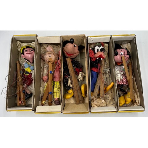 1305 - Five vintage Pelham Puppets to include Pinocchio, Mickey Mouse, Minnie Mouse, Goofy and Rupert The B... 