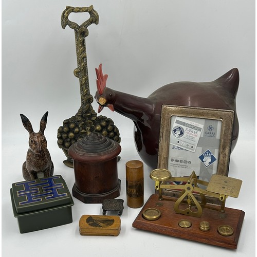 1425 - A miscellany lot to include a brass door stop, a Longchamp pottery chicken measuring 35cm tail to be... 