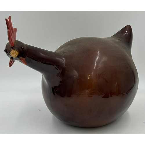 1425 - A miscellany lot to include a brass door stop, a Longchamp pottery chicken measuring 35cm tail to be... 