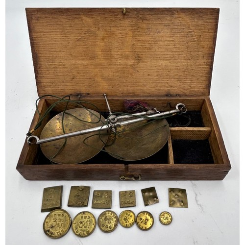 1434 - A miscellany to include apothecary scales with weights, bone handled crop, oak money box without key... 