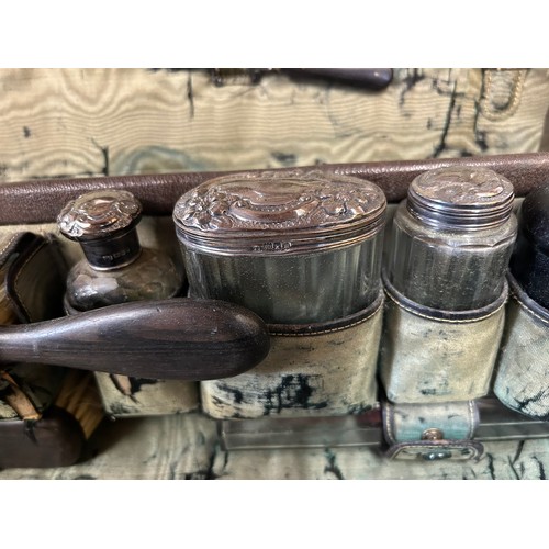 947 - An Edwardian leather Vanity Case comprising of ebony brushes, tweezers, comb, mirror, shoe horn, pow... 