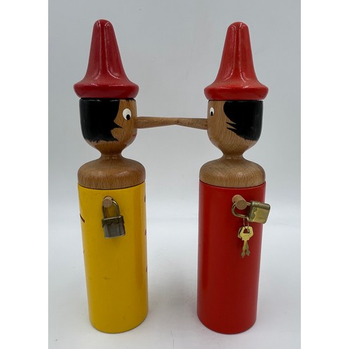 464 - Four Italian wooden Pinocchio figures 2 of which are money boxes with keys. Tallest 51cm.