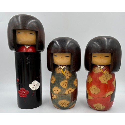 1009 - A collection of traditional wooden hand painted Japanese Kokeshi dolls one which is a keyring larges... 