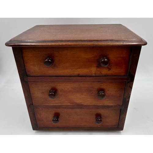 1064 - A mahogany apprentice 3 drawer chest measuring 24cm h along with a oak box with dome tambour with en... 