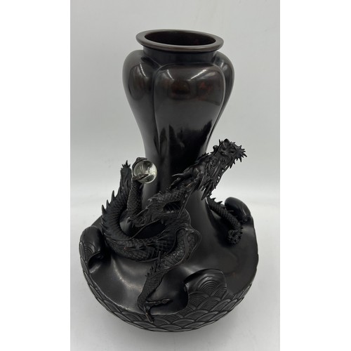 1011 - A Japanese bronze dragon vase, the dragon clutching rock crystal tama. 33cm h.