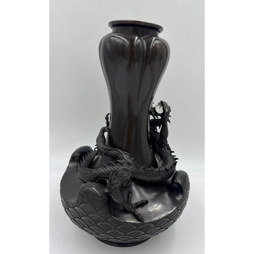 1011 - A Japanese bronze dragon vase, the dragon clutching rock crystal tama. 33cm h.