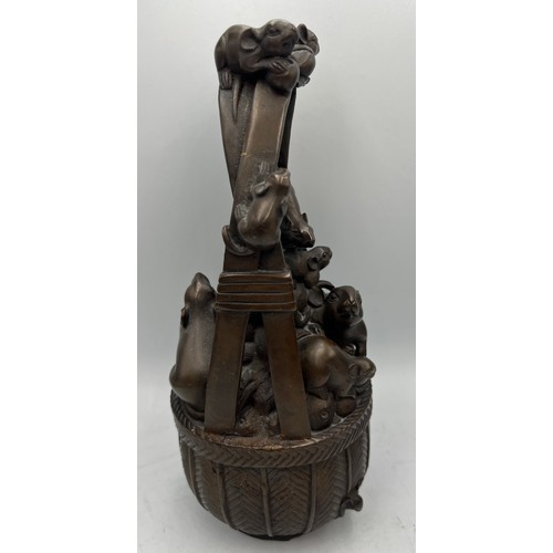 1014 - Japanese bronze rats in a basket. 24cm h.