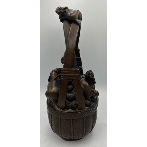 1014 - Japanese bronze rats in a basket. 24cm h.