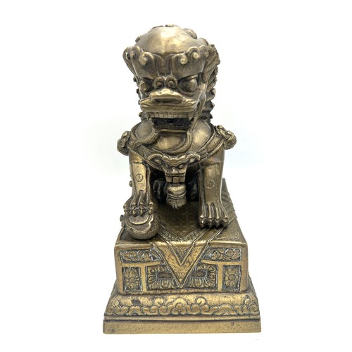 1029 - A late 19thC Chinese bronze Foo dog on stand. 18cm h.