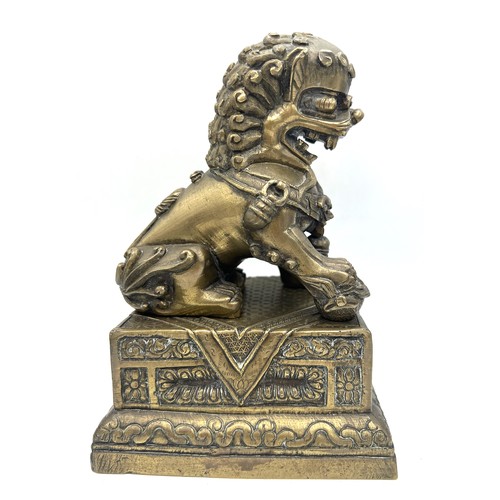 1029 - A late 19thC Chinese bronze Foo dog on stand. 18cm h.