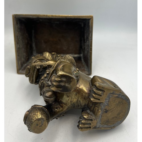 1029 - A late 19thC Chinese bronze Foo dog on stand. 18cm h.