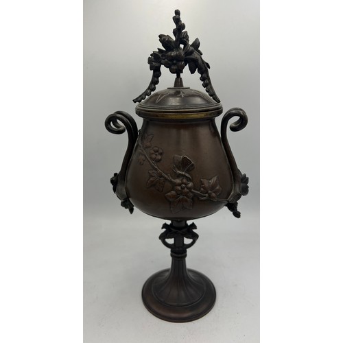 1031 - A 19thC Japanese bronze lidded urn. 24cm h.