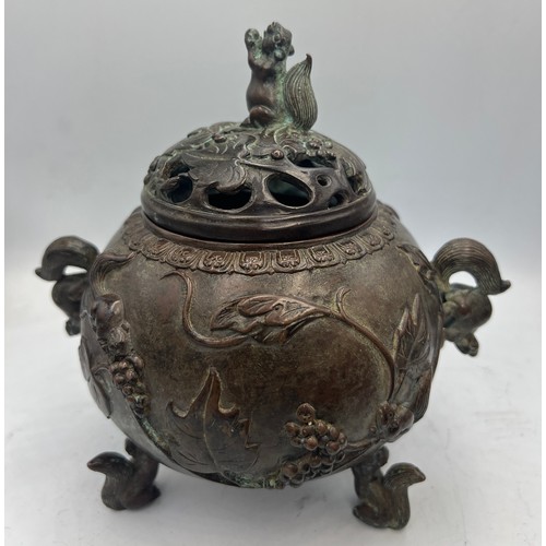 1039 - Two Japanese bronze censors, one with squirrel supports, handles and knop and marks to base. 18cm h.