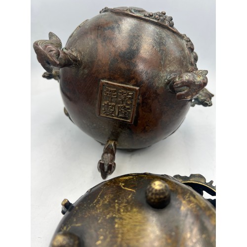 1039 - Two Japanese bronze censors, one with squirrel supports, handles and knop and marks to base. 18cm h.