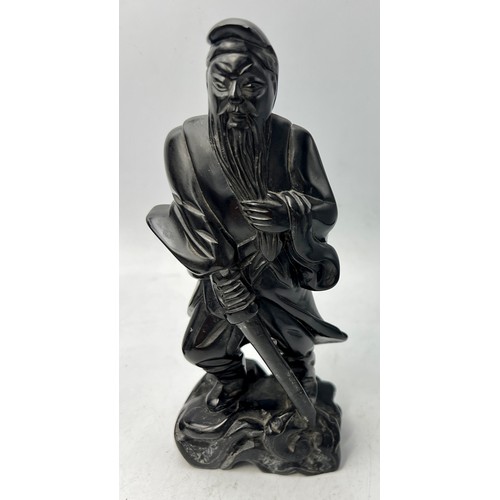 1043 - A Japanese bronze figure of a fisherman 30cm h together with two carved black stone figures of gentl... 