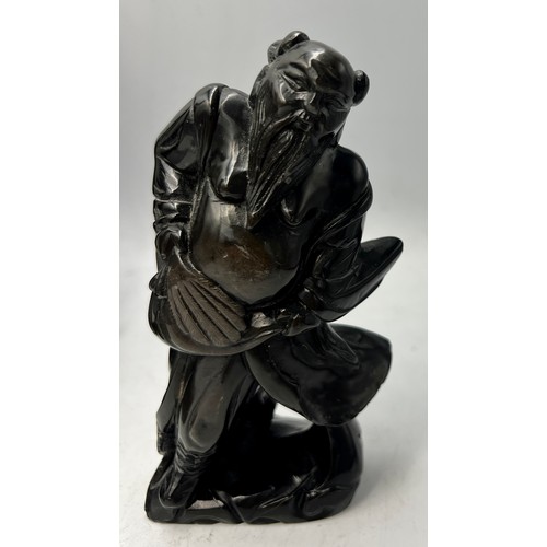 1043 - A Japanese bronze figure of a fisherman 30cm h together with two carved black stone figures of gentl... 