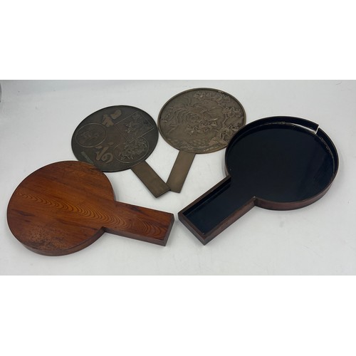 1044 - Two Japanese bronze hand mirrors in a lacquered case. 32cm x 20cm.