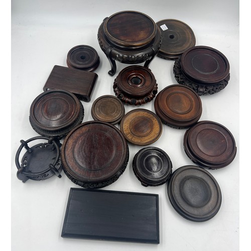 1048 - A large quantity of oriental wooden stands. (16)