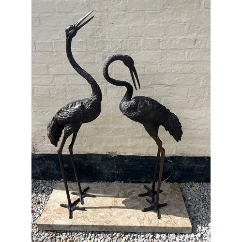 1052 - A pair of Japanese bronze cranes on later marble base. Height 132cm.