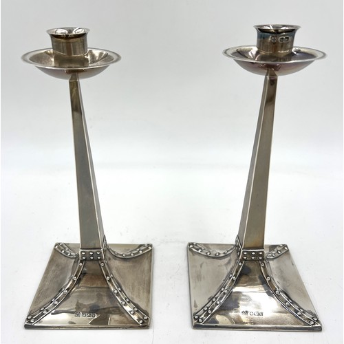 856 - A pair of Arts and Crafts silver candlesticks with weighted bases. Sheffield 1905, maker R&W Sorley ... 