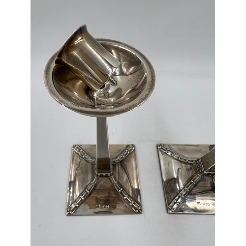 856 - A pair of Arts and Crafts silver candlesticks with weighted bases. Sheffield 1905, maker R&W Sorley ... 