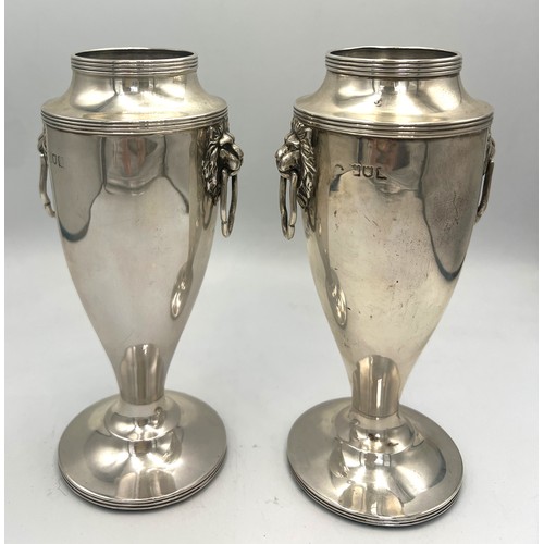 862 - A pair of silver vases with lion mask drop handles and weighted bases. 15cm h. Weight 700gm. London ... 