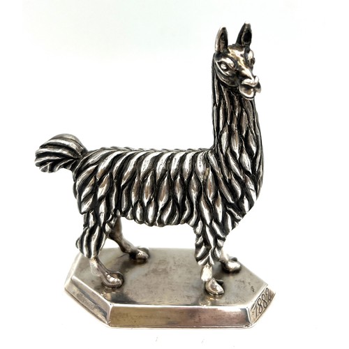 871 - A Colombian white metal llama/alpaca figure. 9.5cm h. Weight 217gm. Marked to base Plateria de Rodri... 