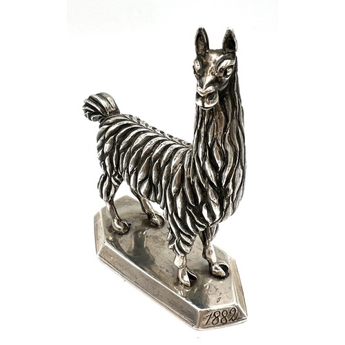 871 - A Colombian white metal llama/alpaca figure. 9.5cm h. Weight 217gm. Marked to base Plateria de Rodri... 