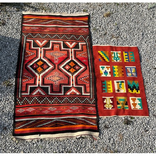 1287 - A multicoloured Kilim rug 143 x 79cm together with a red, orange and black wool rug 258 x 126cm.