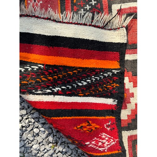 1287 - A multicoloured Kilim rug 143 x 79cm together with a red, orange and black wool rug 258 x 126cm.