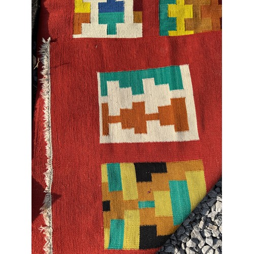 1287 - A multicoloured Kilim rug 143 x 79cm together with a red, orange and black wool rug 258 x 126cm.