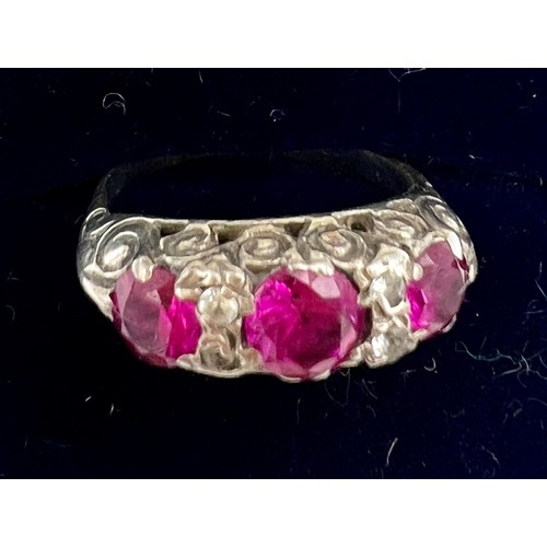 702 - An unmarked white metal ring set with pink and clear stones. Size H/I, weight 2.1gm.