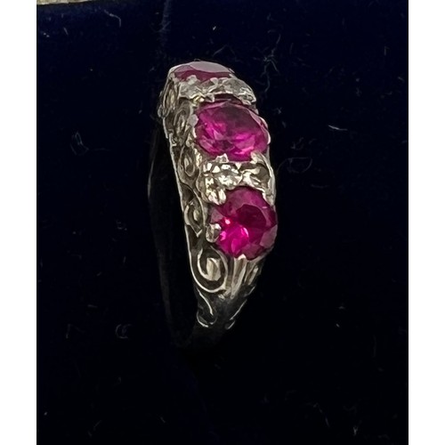 702 - An unmarked white metal ring set with pink and clear stones. Size H/I, weight 2.1gm.