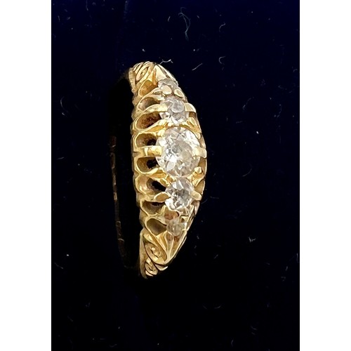 707 - An 18 carat gold ring set with five diamonds. Size M. Weight 3.2gm.