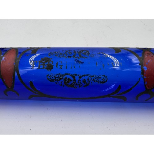 495 - A 19thC blue glass decorated rolling pin. 37cm l.