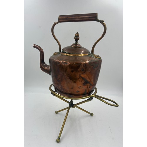 1070 - A 19thC folding brass trivet together with a 19thC copper kettle. 31cm h.