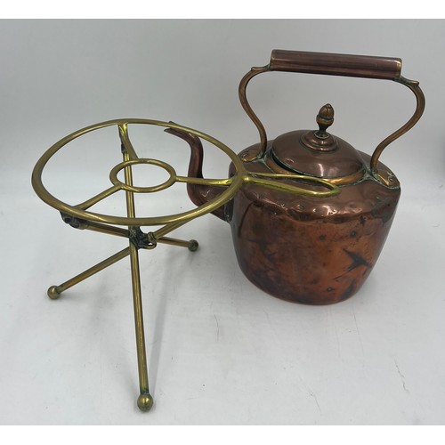 1070 - A 19thC folding brass trivet together with a 19thC copper kettle. 31cm h.