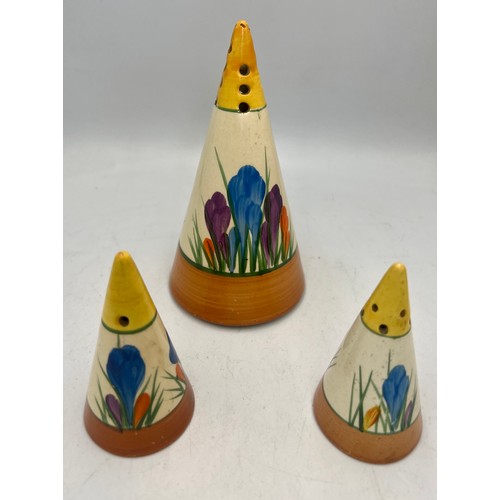 387 - A pair of Clarice Cliff Bizarre crocus pattern salt, pepper and sugar shaker, 14cm h.