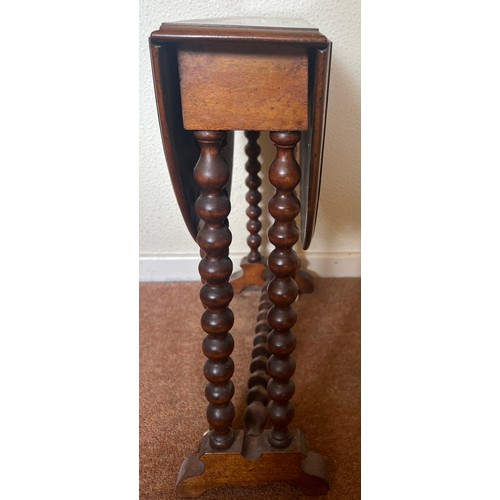 59 - A 19thC mahogany Sutherland table with bobbin turned supports on ceramic casters. 73cm open  x 57cm ... 