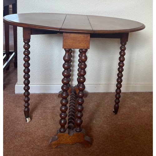 59 - A 19thC mahogany Sutherland table with bobbin turned supports on ceramic casters. 73cm open  x 57cm ... 