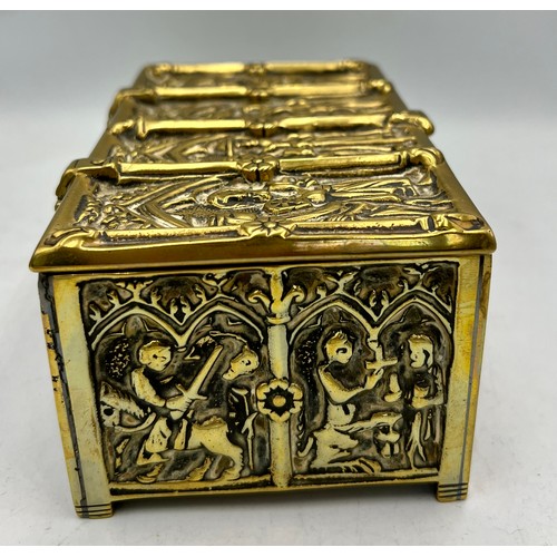 1071 - A brass wood lined casket depicting religious scenes. 15cm x 9 cm x 7cm h together with a tiny Buddh... 