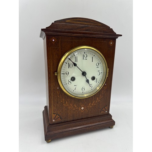 1124 - A mahogany mantel clock, inlaid with satinwood and mother of pearl with enamelled face 32cm x 21.5cm... 