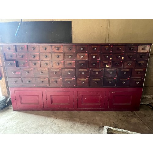 64 - Nineteenth century drug run/drawers, multiple drawers over cupboards to base. 268cm l x 137cm h x 30... 