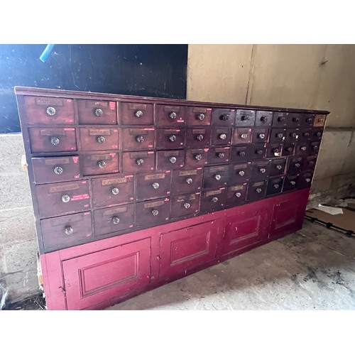 64 - Nineteenth century drug run/drawers, multiple drawers over cupboards to base. 268cm l x 137cm h x 30... 