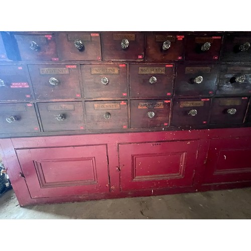 64 - Nineteenth century drug run/drawers, multiple drawers over cupboards to base. 268cm l x 137cm h x 30... 